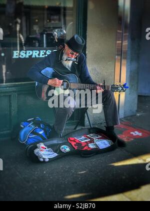 Musician playing in front of a coffee house in Pikes Market, Seattle Washington Stock Photo