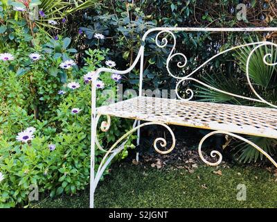 Metal bench in garden Stock Photo