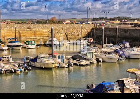Marina with private boats moored up in sunshine Stock Photo