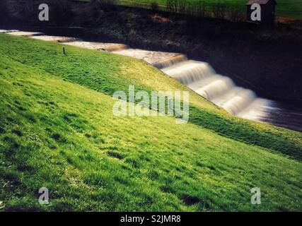 Water flowing from reservoir overflow. Overflow from Rivington reservoir in Lancashire Stock Photo