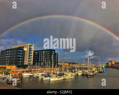 Rainbow over Penarth marina on a stormy afternoon in March. Stock Photo