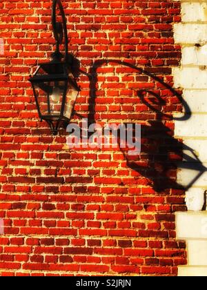 Wall lamp and shadow on an old french chateau. Stock Photo