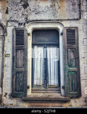 Old shuttered window on a french building Stock Photo