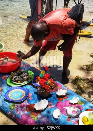 Man selling fresh oysters on the beach