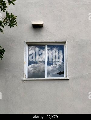Storm clouds reflected in an apartment window. Stock Photo