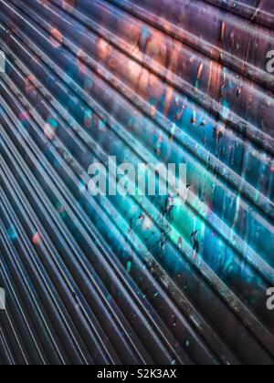 Colourful paint splatter effect on closed security shutter Stock Photo