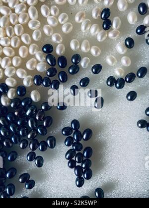 Selection of white and peacock freshwater pearls. Abstract background Stock Photo