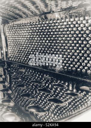 Reflections in a cheese grater Stock Photo