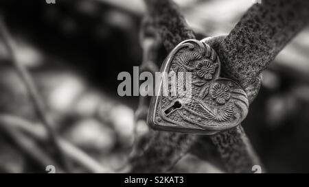 Ornate heart shaped love lock on trestle bridge Stock Photo