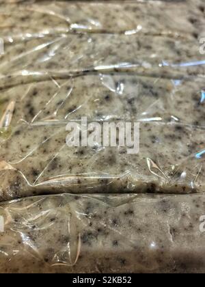 Full frame of tasty delicious mouth watering kitchen fresh oreo cookie fudge packaged in plastic wrap. Stock Photo