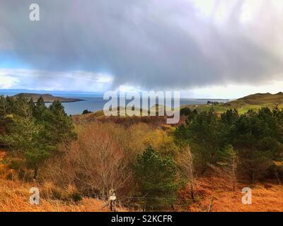 A view from the Quiraing mountain range on the Isle of Skye near Flodigarry and Staffin in Scotland on the 2nd of April 2019. Looking towards the sea. Stock Photo