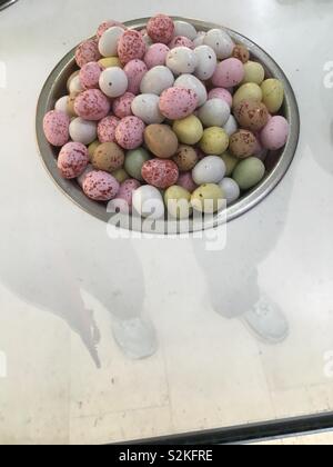 Little chocolate eggs in a bowl Stock Photo