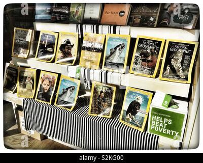Oxfam book shop window displaying National Geographic magazines Stock Photo