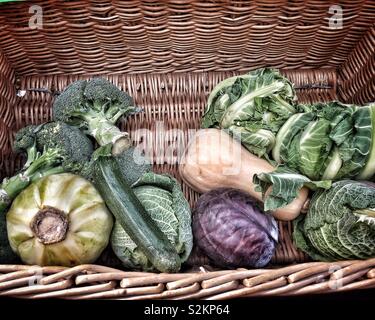 Selection of fresh vegetables in a wicker basket. Stock Photo