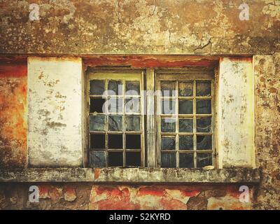 Broken windows at an abandoned building Stock Photo