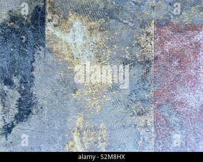 Concrete floor with remains of colored floor covering on the rough, textured surface Stock Photo