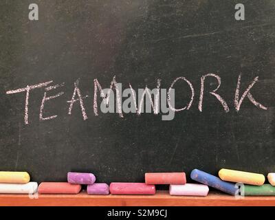 Teamwork written on a chalkboard Stock Photo