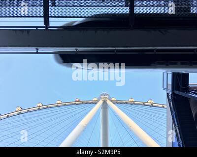 LAS VEGAS, NV, APRIL 2019: looking up past monorail with train passing at High Roller big wheel at the back of casinos on The Strip Stock Photo