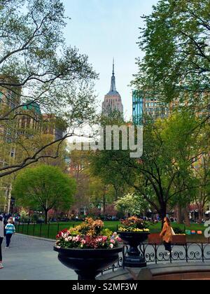 The Empire State building as seen from the South fountain Plaza in Madison Square, Park, NYC, United States Stock Photo