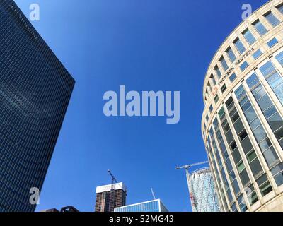 JP Morgan building on the left and the Thomson Reuter’s building on the right on Canary Wharf in London, England on April 30 2019 Stock Photo