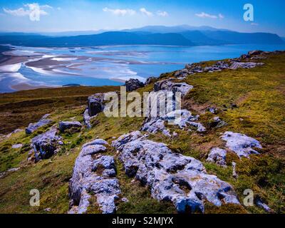 View looking down to the sea from the summit of the Great Orme near Llandudno in North Wales with exposed rocks in the foreground. Stock Photo