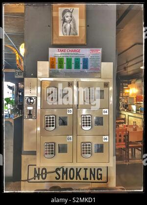 Phone charging dock at Tiger’s Milk, Kloof Street, Cape Town, South Africa. Stock Photo