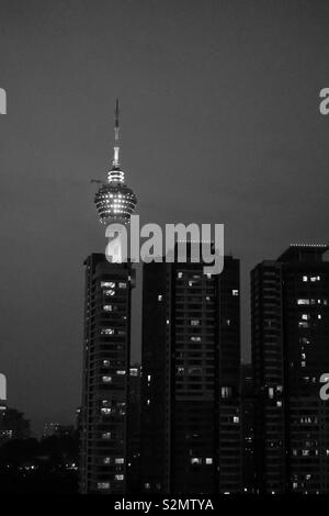 Kuala Lumpur by night. Apartment buildings and one TV Tower. Black and white Stock Photo