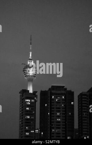 Kuala Lumpur by night. Apartment buildings and one TV Tower. Black and white Stock Photo