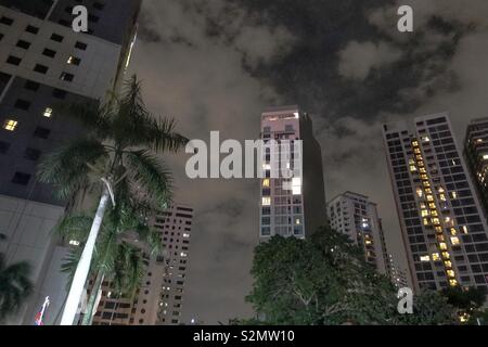 Kuala Lumpur by night - some block of flats, apartment buildings with a dramatic sky and some trees. Stock Photo