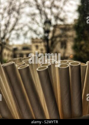 Closeup of a bunch of paper straws that are biodegradable and good for the environment with a very fancy house in the distant background. Stock Photo