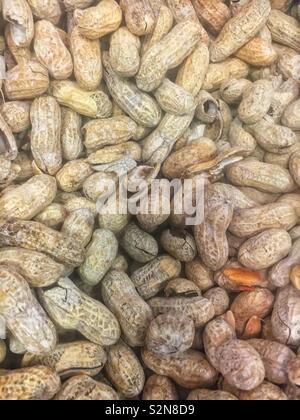 Full frame box full of peanuts roasted and salted in the shell. Stock Photo