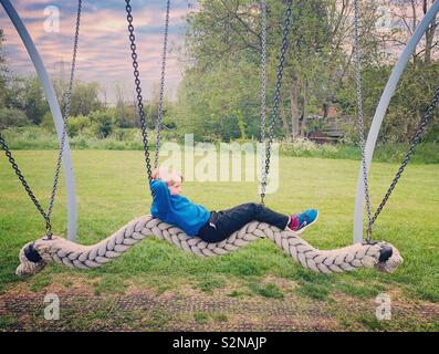 Boy on a Rope Swing Stock Photo
