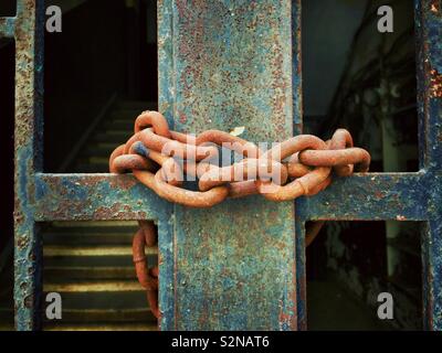 Rusted chin on old gate Stock Photo