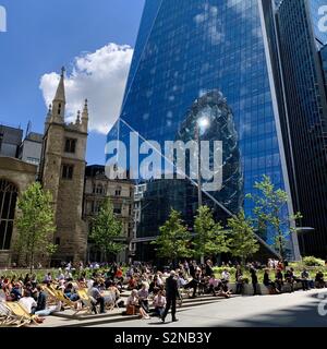 London, UK - 21 May 2019: Hot in the City. Workers relax outside on a bright warm Tuesday afternoon. Stock Photo