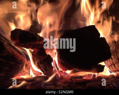 Close-up of wood burning in an outdoor fireplace. Stock Photo