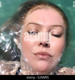 Woman floating in Aegean Sea Stock Photo