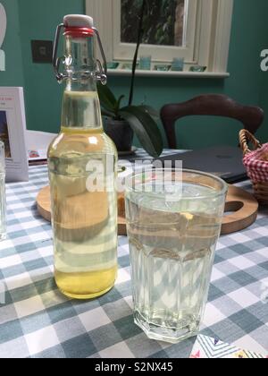 Elderflower cordial spring drink bottle glass country table Stock Photo