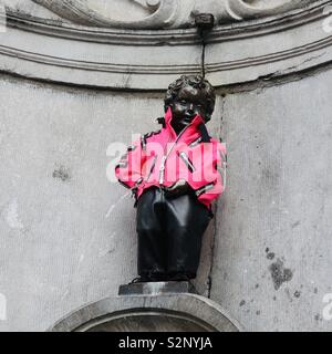 Brussels, Belgium - 29 May 2019: Mannekin Pis in a bright pink jacket. Stock Photo