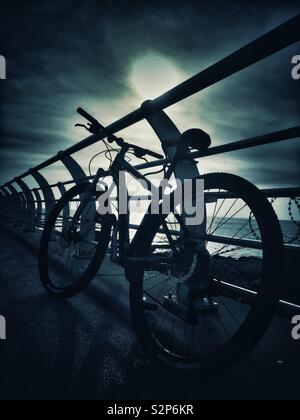 Bike silhouette on the beach Stock Photo