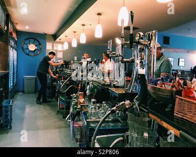 A man working behind a bar in a pub. Stock Photo