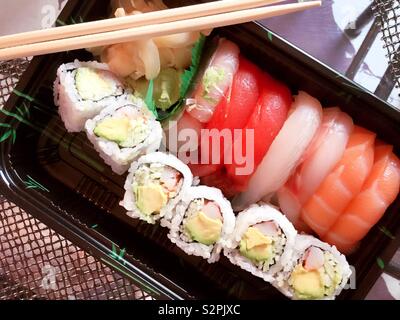A Japanese delivery meal of sushi pieces and California roll, New York City, USA Stock Photo