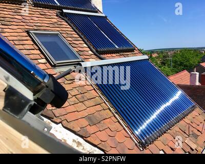 Solar thermal evacuated tubes to heat water on tile roof of large ...