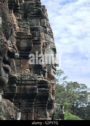 Carved faces at Angkor Thom temple in Cambodia Stock Photo