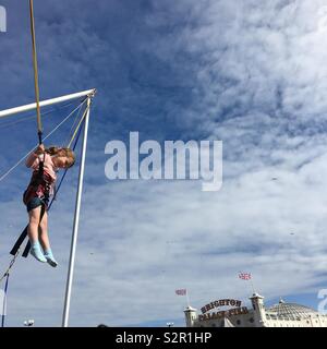 Little girl on bungee trampoline Stock Photo