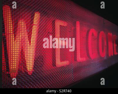 Neon welcome sign in red with mesh Stock Photo