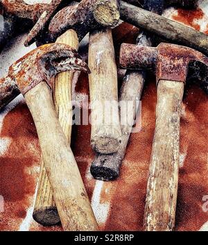 Old wooden handled rusty claw hammers and lump hammer Stock Photo