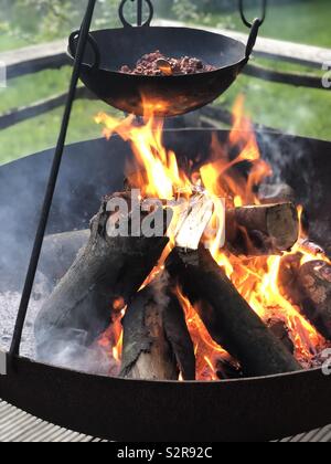 Cooking chilli over a firepit Stock Photo