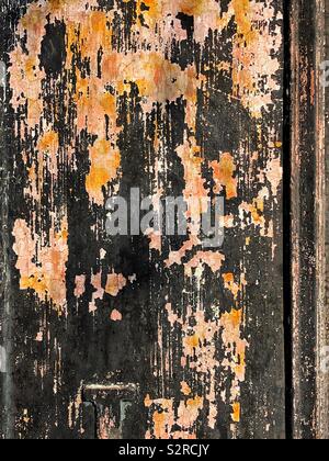 Peeling and flaking paint on rusty metal Stock Photo