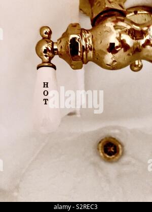 Antique brass “hot” water faucet Stock Photo