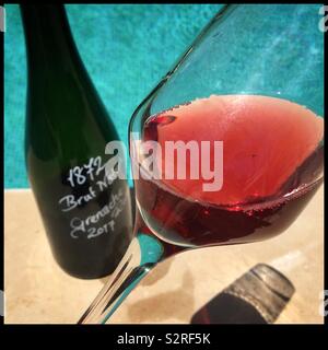 A glass of homemade sparkling Grenache rosé poolside on a summer’s day, Catalonia, Spain. Stock Photo